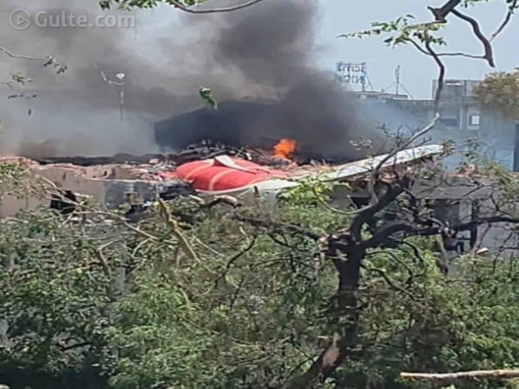 Air India Flight AI171 crash site in Ahmedabad with heavy smoke and debris near residential buildings